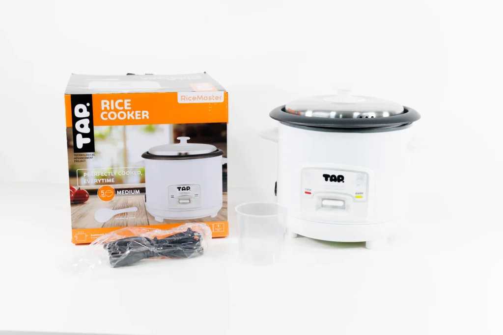 TAP rice cooker next to its packaging box